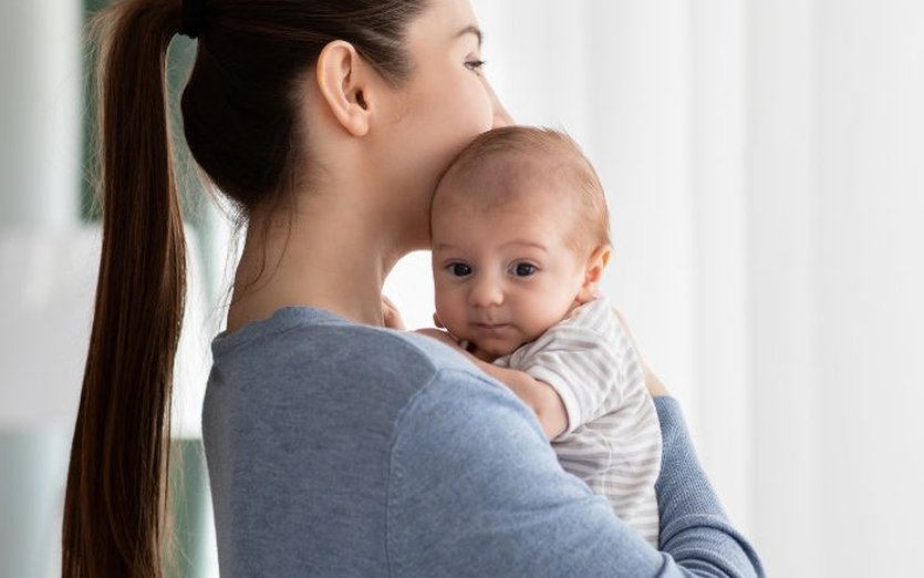 Happy woman holding baby