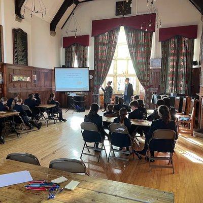 Giant Digital delivering a session to students at Kirkham Grammar School as part of BIMA Digital Day, with pupils seated at tables and presenters speaking at the front of the hall.