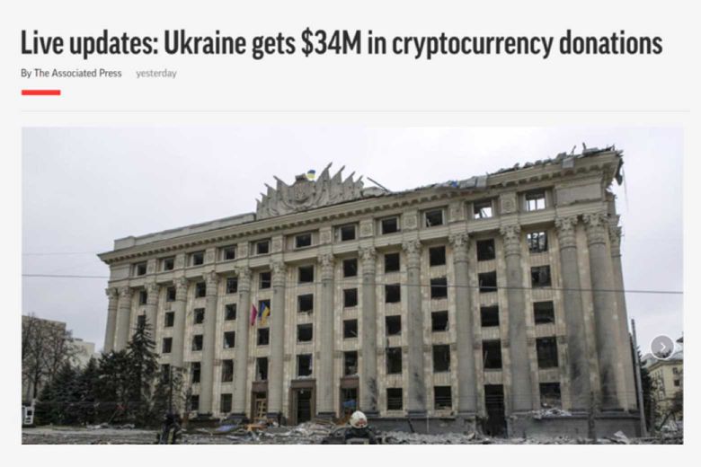 news article showing bombed building and headline stating Ukraine gets $34m in cryptocurrency donations