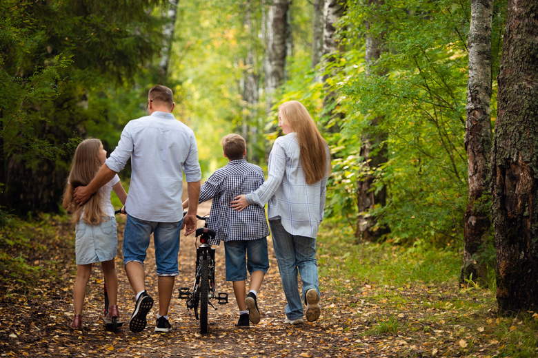 a family enjoying a walk in the forest
