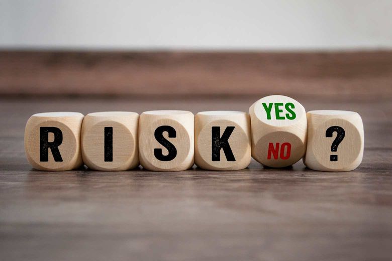 several dice lined up with the word risk spelled out