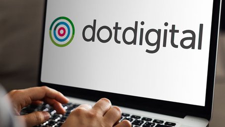 Person using a laptop displaying the Dotdigital logo on the screen.