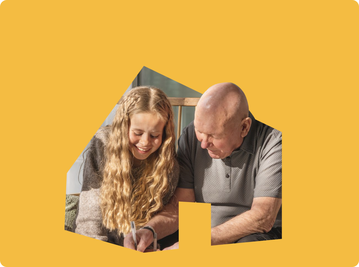 Two people smiling within a cut out of the Maggie's logo